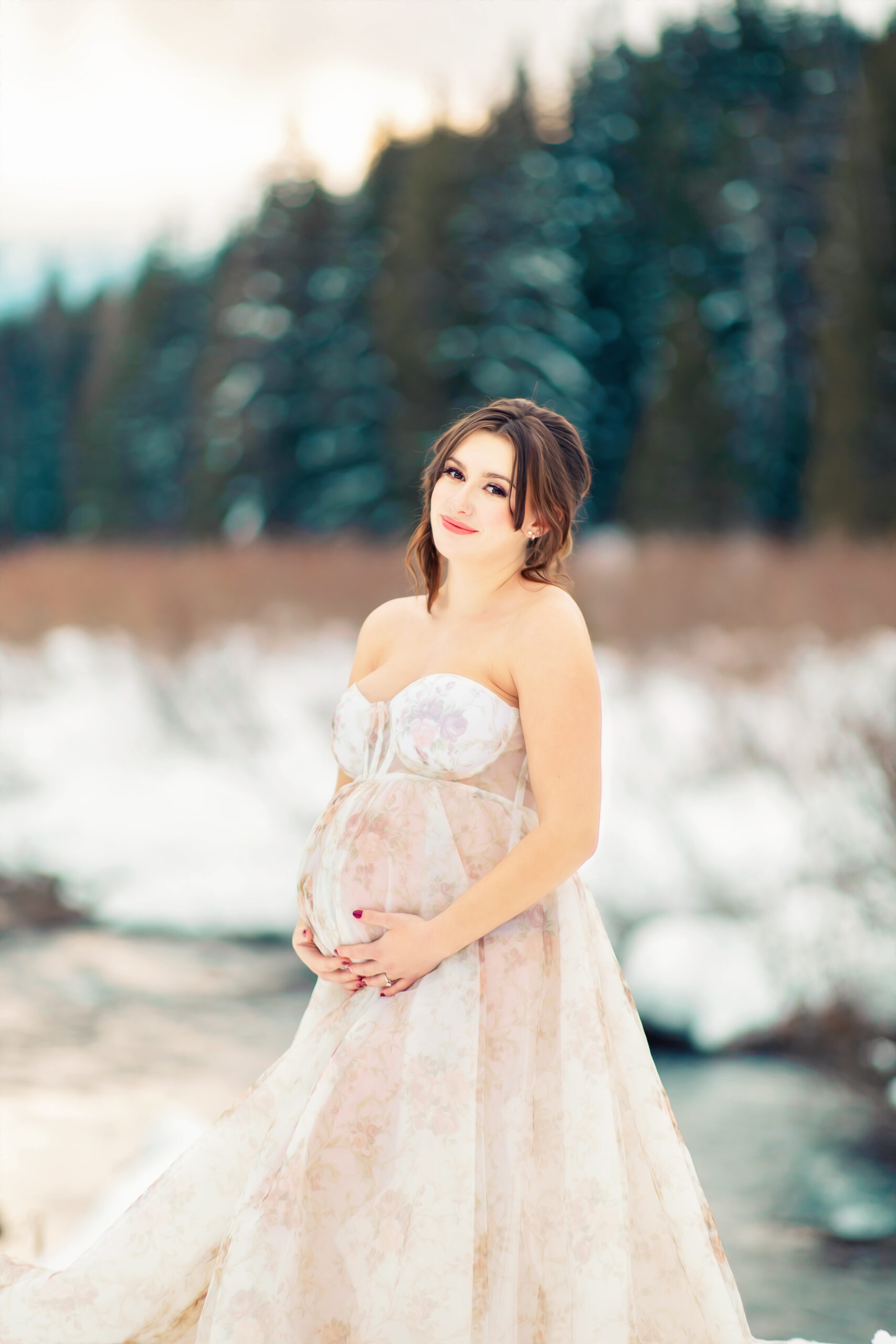 Pregnant woman in white gown against the Snoqualmie Snow